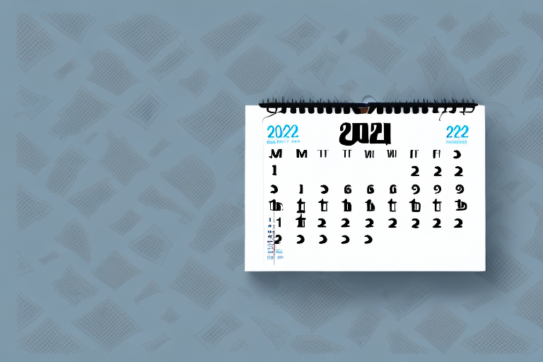 A wall calendar displaying December 2022 and January 2023 is open to January. The background features a pattern of scattered papers on a gray surface, serving as a perfect guide for planning ahead.